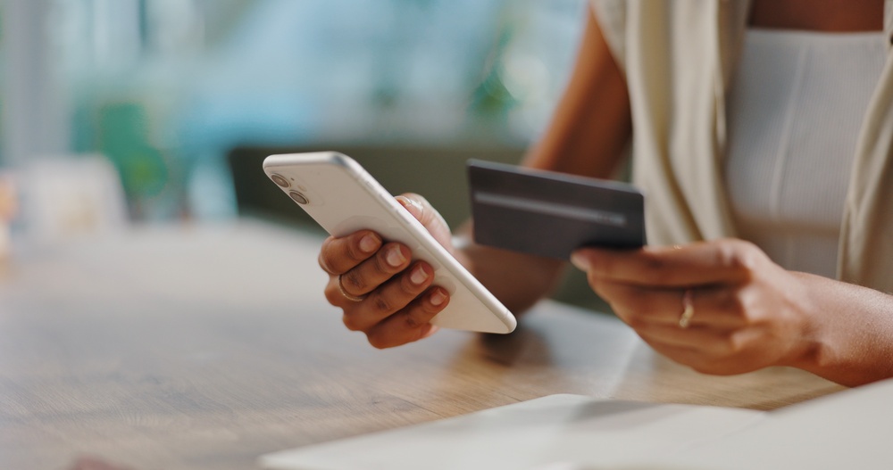 black woman making payment with her ATM card